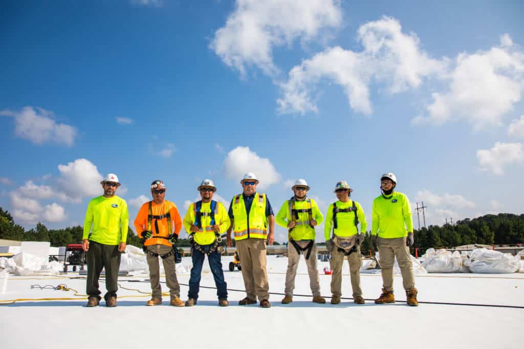 group of roofers on a flat roof
