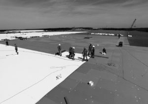 Mid-South Roof Systems Team Members atop a roof working