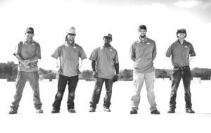 Diverse group of Mid-South Roof Systems Team Members atop a roof