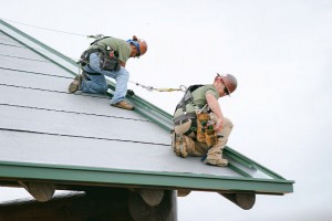 Mid-South Roof Systems sheet metal workers atop roof pitch workiing