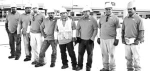 Mid-South Roof Systems Team Members atop a roof smiling
