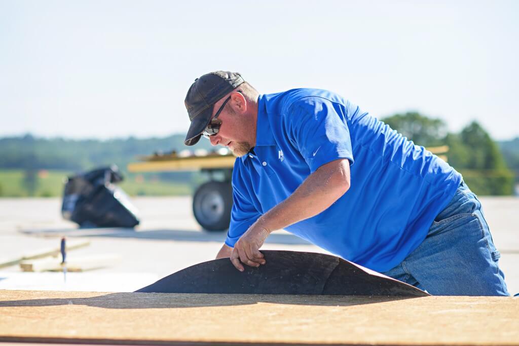 Mid-South-Roof Systems team member working on Walk Pads commercial roof