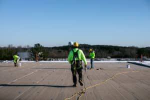 commercial roofers on top of flat roof