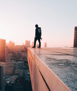 Man standing on the edge of a rooftop