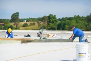 Mid-South Roof Systems Team Members atop a roof doing roofing work
