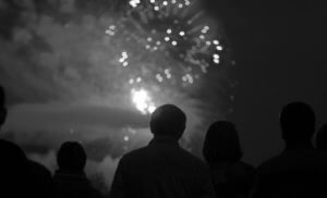 A small crowd of people watching fireworks