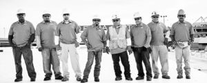 Mid-South Roof Systems Team Members atop a roof posing for group portrait